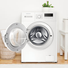 White washing machine with open door in a room with wooden floor and white walls.