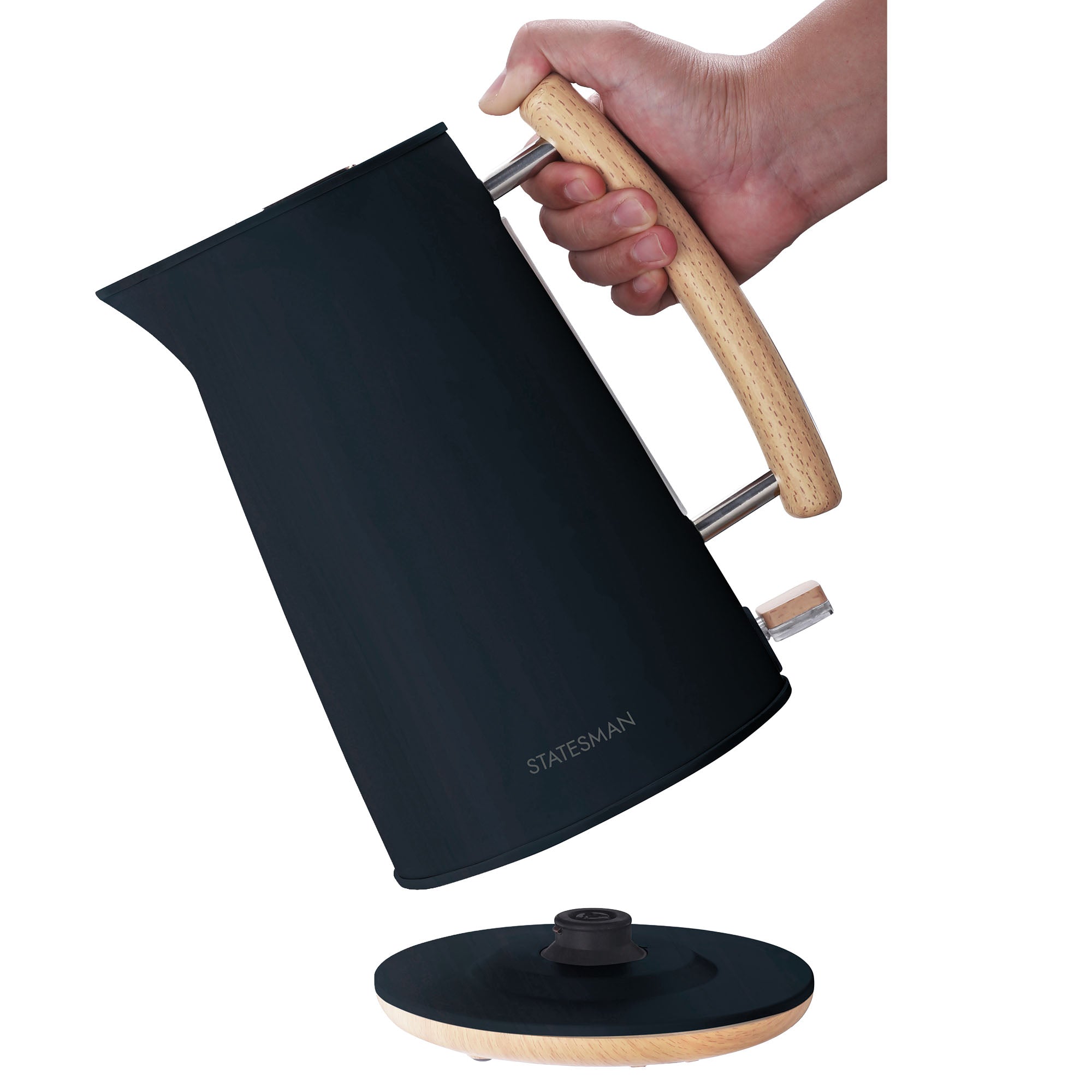 A hand holds the Statesman 1.7L Scandi Kettle with a wooden handle above its cordless base, showcasing the Statesman Appliances logo and the kettle's sleek 3000W design.