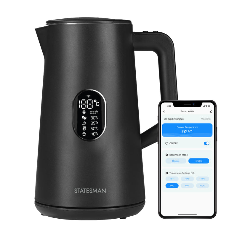 The Statesman Appliances 1.5L 1800W Smart Jug Kettle in black, with temperature control and LED display, sits beside a smartphone showing its app with temperature and power options, emphasizing Alexa compatibility.