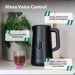 The Statesman Appliances 1.5L 1800W Smart Jug Kettle in black sits on a countertop beside a glass of tea and plant, with Alexa-compatible voice commands like “Alexa, turn on the kettle” and “Alexa, set the kettle to 85 degrees.”.