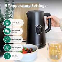 A hand holds the handle of a black Statesman Appliances 1.5L 1800W Smart Jug Kettle with five temperature settings (40°C–100°C) on a kitchen counter, next to strawberries and a glass mug with a hot drink.