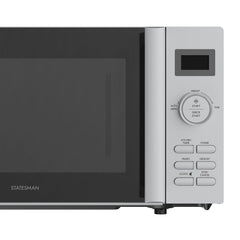 A close-up of the Statesman Digital Microwave, 20 Litre 800W Silver control panel shows a digital display, auto cooking programs, and buttons for power, defrost, clock, start, and stop/cancel beside the door with a stainless steel cavity.