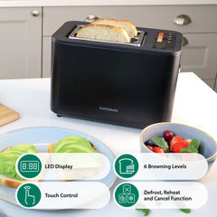 A black Statesman Appliances 900W 2 Slice Digital Toaster sits on a kitchen counter with avocado toast and berries nearby. It has wide slots, an LED display, touch controls, and 6 browning levels.