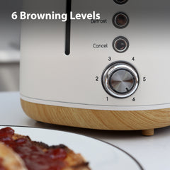Close-up of the Statesman Appliances 900W 2 Slice Scandi Toaster, featuring a silver dial for 6 browning levels, Defrost and Cancel buttons. The large slot fits thicker slices. Plate of toast with jam in foreground; text reads "6 Browning Levels".