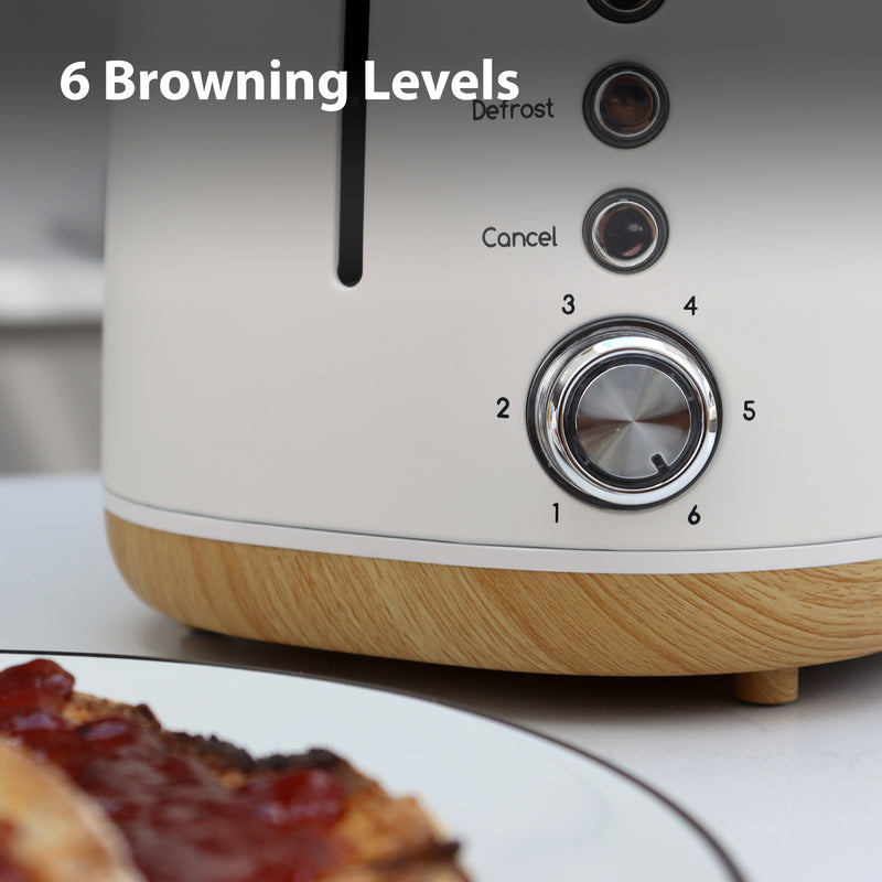 Close-up of the Statesman Appliances 900W 2 Slice Scandi Toaster, featuring a silver dial for 6 browning levels, Defrost and Cancel buttons. The large slot fits thicker slices. Plate of toast with jam in foreground; text reads "6 Browning Levels".